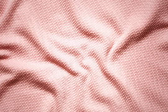 Pink crumpled fabric background