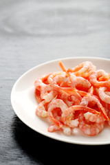 Fresh boiled shrimps on a black wooden table