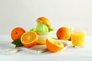 Citrus fruits with juicer on a blue wooden table