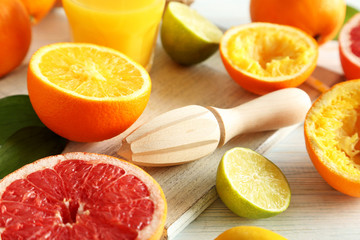 Citrus fruits with juicer on a blue wooden table