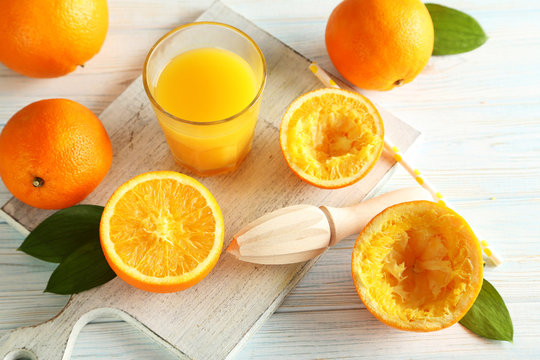 Citrus fruits with juicer on a blue wooden table