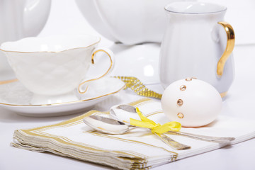 Egg decorated with rhinestones lies on a napkin next to the silv