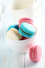 Tasty french macarons on a blue wooden table