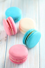 Tasty french macarons on a blue wooden table