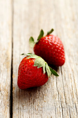 Ripe red strawberry on a grey wooden table