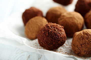 Sweet chocolate truffle on a blue wooden table