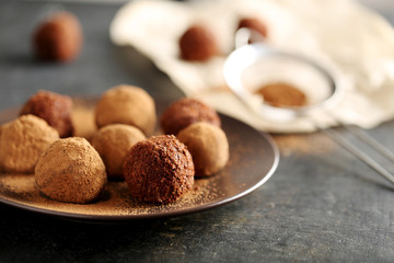 Sweet chocolate truffle on a black wooden table