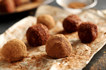Sweet chocolate truffle on a black wooden table