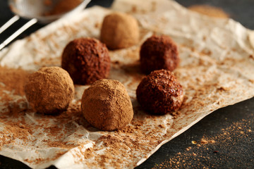 Sweet chocolate truffle on a black wooden table