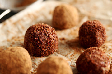 Sweet chocolate truffle on a black wooden table