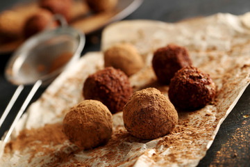 Sweet chocolate truffle on a black wooden table
