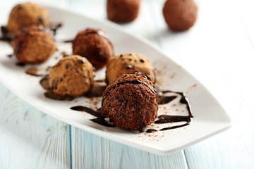 Sweet chocolate truffle on a blue wooden table