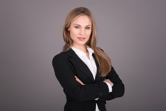 Portrait of wonderful young business woman on gray background