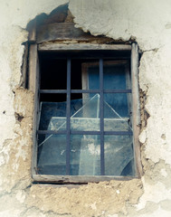 Old window on ruined wall