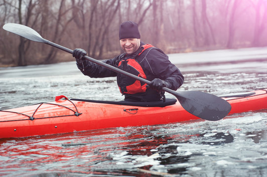 Sports cheerful man in kayak