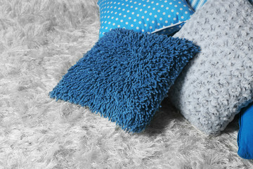 Decorative pillows on grey background, close-up