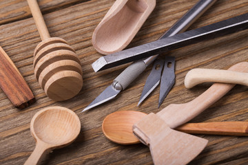 Wooden utensils and tools to create them, closeup