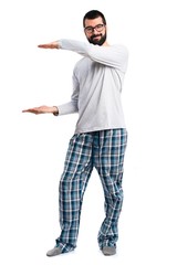Man in pajamas holding something