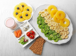 Fruits and vegetables on light wooden background. healthy eating concept.