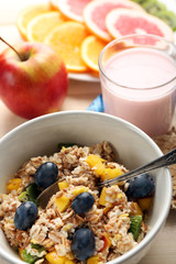 Tasty oatmeal and fruits on wooden background. Healthy eating concept.