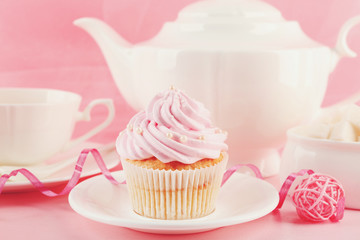 Tasty cupcakes with tea set and decorations, closeup