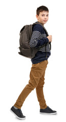 Fototapeta premium Cute little boy with grey backpack going right, isolated on white