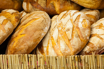 many brown rustic fresh rye bread loaves