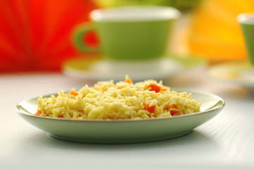 Stewed rice with a carrot on a plate