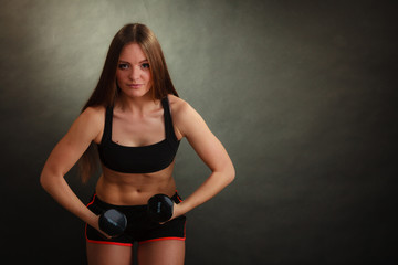 Fototapeta na wymiar Fit woman exercising with dumbbells.