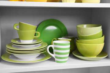 Tableware on shelf in the kitchen cupboard