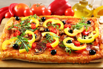 Rectangle delicious pizza and vegetables on the table