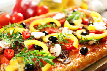 Delicious rectangle pizza on the table, close-up