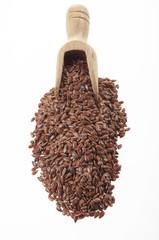 Flax seeds with a small wooden spoon