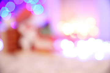 Blurred background of Christmas gift boxes and decoration on the soft carpet