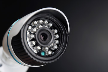 Security CCTV camera on grey background, closeup