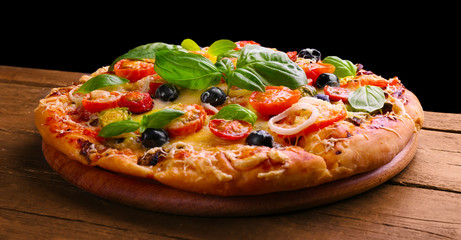Delicious fresh pizza on black background