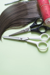 hairdresser tools on green paper background