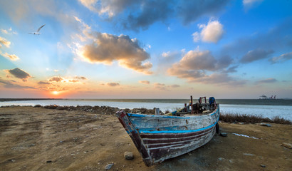 old wooden fishing boat at sunset