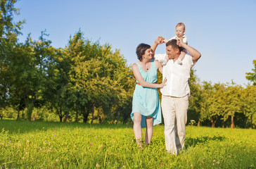 Human Relationships Concepts. Young Caucasian Family of Three People Outdoors
