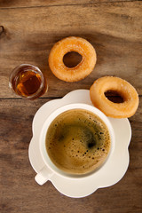 coffee and donuts on wooden table