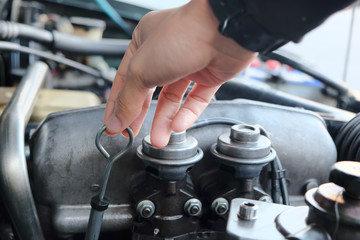 
Image of a car mechanic checking the oil level. auto repair background