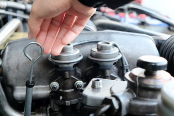 
Image of a car mechanic checking the oil level. auto repair background
