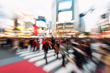 Evening rush hour at the famous Shibuya Crossing in Tokyo, Japan. This area is known as one of the fashion centers of Japan.