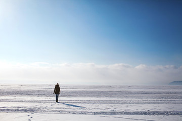 girl walking on the frozen lake Baikal
