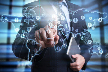 businessman using modern computer and pressing button on virtual screen with world map. global...