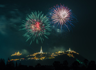 Fireworks show at night with pagoda foreground