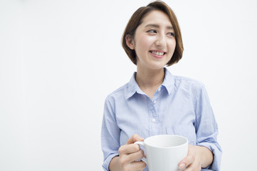 Woman smiling with a white mug