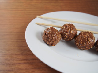 Milk chocolate balls with crisp hazelnut, snack, high calorie, fat, souvenir in Valentines Day