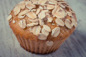 Vintage photo, Fresh muffin with oatmeal baked with wholemeal flour, delicious healthy dessert