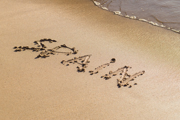 Inscription Spain on the sand beach